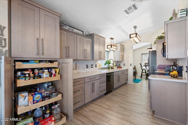 kitchen with light hardwood / wood-style floors, decorative light fixtures, sink, stainless steel appliances, and backsplash