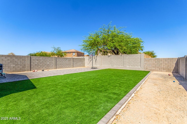 view of yard featuring a patio and a fenced backyard