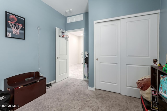 interior space featuring a closet, carpet floors, and baseboards