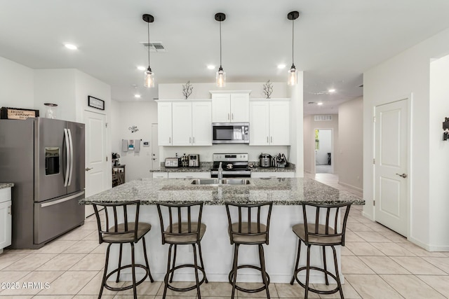 kitchen featuring light tile patterned floors, stainless steel appliances, a kitchen breakfast bar, and stone countertops