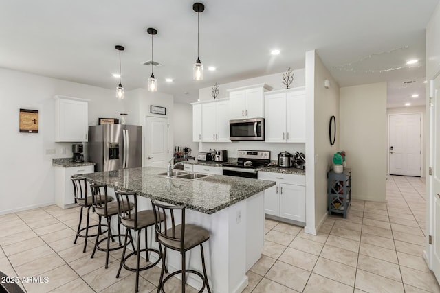 kitchen with light tile patterned floors, a breakfast bar, recessed lighting, and appliances with stainless steel finishes