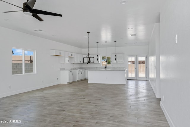 kitchen featuring french doors, plenty of natural light, and white cabinets