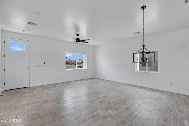 unfurnished living room featuring light wood-style floors, ceiling fan, and visible vents