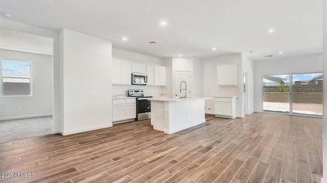 5842 E Axle Ln, San Tan Valley, AZ 85140 - kitchen with stainless steel appliances, light wood-type flooring, light countertops, baseboards, and recessed lighting