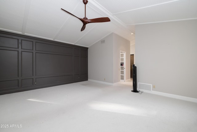 additional living space featuring lofted ceiling with beams, a decorative wall, light carpet, visible vents, and baseboards