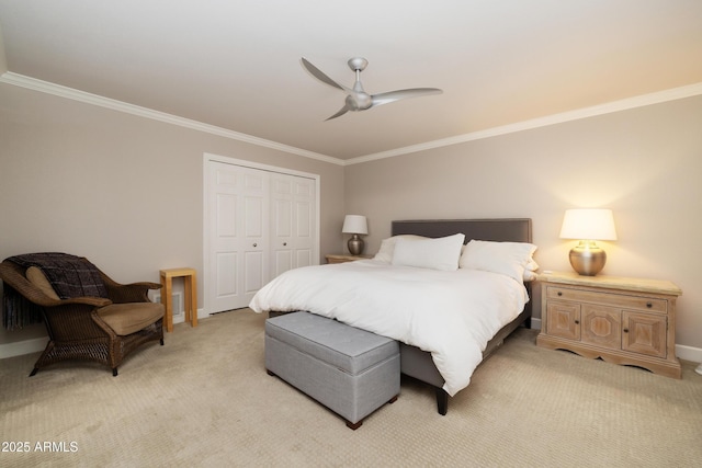 bedroom with crown molding, ceiling fan, a closet, and light colored carpet