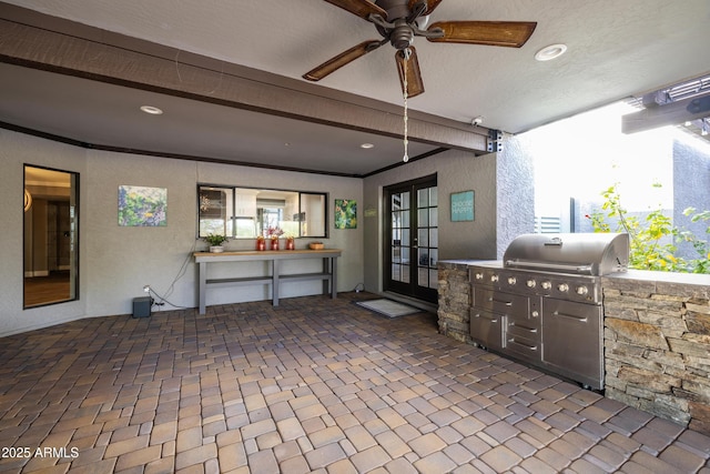 view of patio / terrace featuring a ceiling fan, french doors, a grill, and an outdoor kitchen