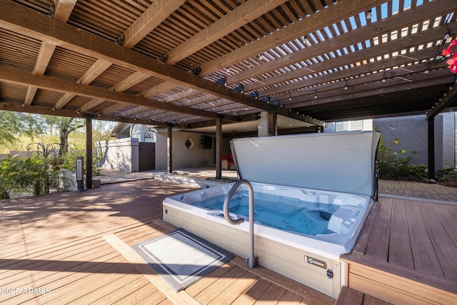 deck featuring a pergola and hot tub deck surround