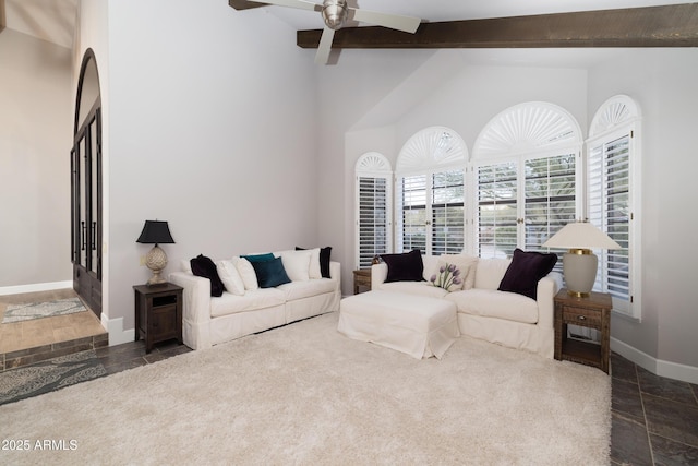 living area featuring vaulted ceiling with beams, baseboards, and a ceiling fan