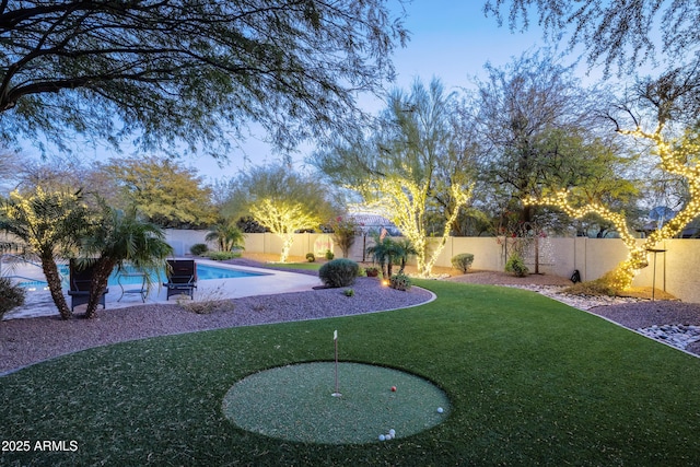 view of yard featuring a fenced in pool and a fenced backyard