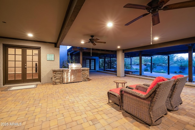 view of patio featuring french doors, area for grilling, a grill, and a ceiling fan