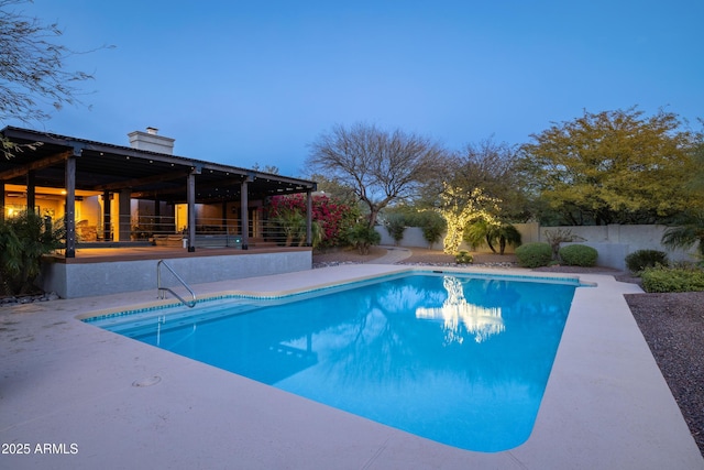 view of swimming pool featuring a patio area, fence, and a fenced in pool