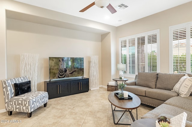 tiled living room featuring ceiling fan