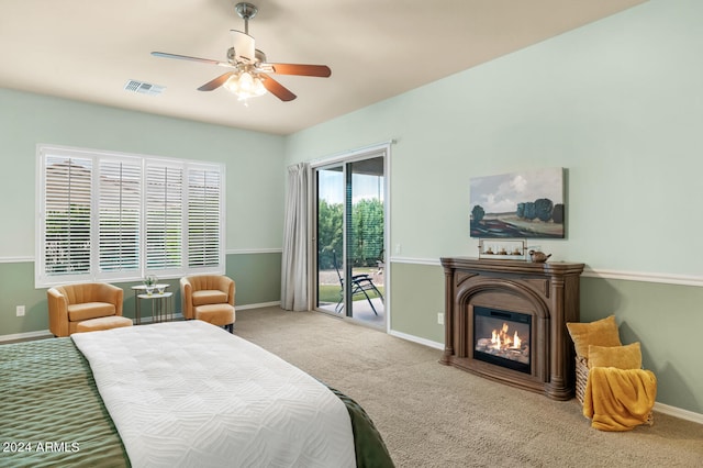 carpeted bedroom featuring ceiling fan and access to exterior