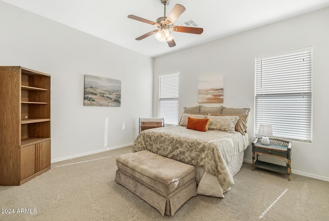 bedroom with ceiling fan and light colored carpet