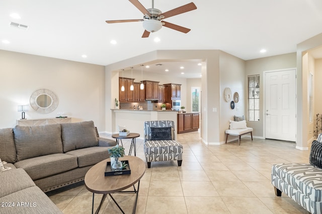 tiled living room featuring ceiling fan