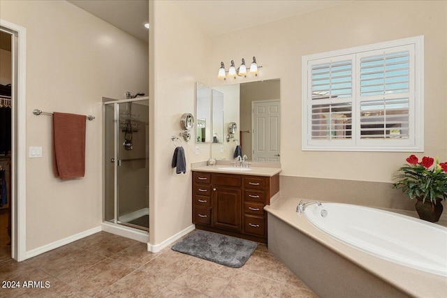 bathroom featuring tile patterned floors, plus walk in shower, and vanity