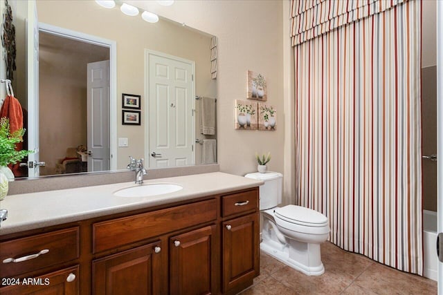 bathroom featuring tile patterned floors, vanity, and toilet