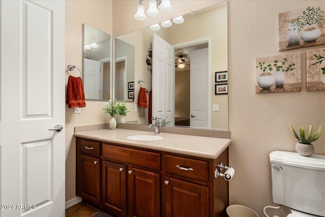 bathroom with ceiling fan, toilet, and vanity