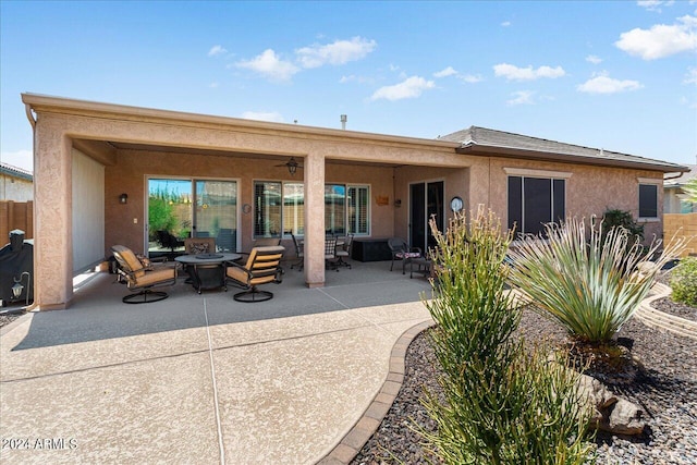 back of property featuring a patio area, an outdoor living space, and ceiling fan