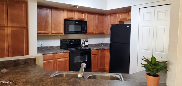 kitchen featuring sink and black appliances