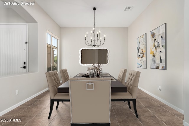 4215 W Hackamore Dr, Phoenix, AZ 85083 - dining room featuring a chandelier, arched walkways, baseboards, and dark tile patterned flooring