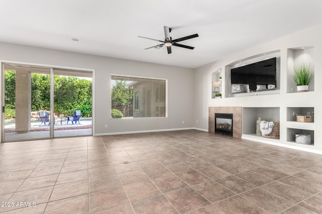 4215 W Hackamore Dr, Phoenix, AZ 85083 - unfurnished living room featuring tile patterned flooring, built in shelves, a ceiling fan, and a tile fireplace