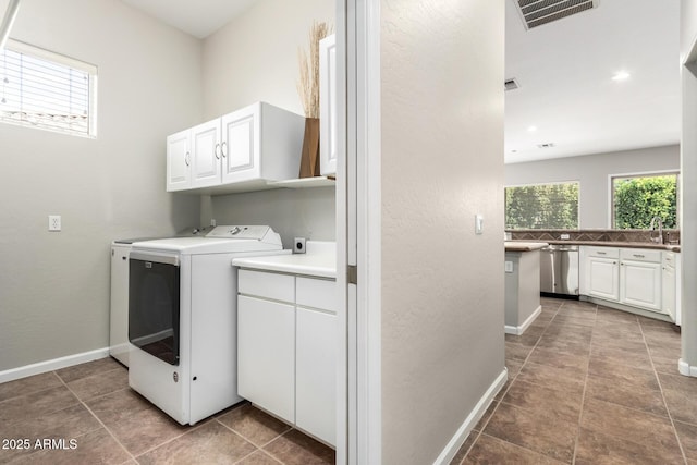 4215 W Hackamore Dr, Phoenix, AZ 85083 - washroom with cabinet space, independent washer and dryer, tile patterned floors, and baseboards