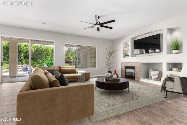 4215 W Hackamore Dr, Phoenix, AZ 85083 - tiled living room with ceiling fan, a tile fireplace, and baseboards