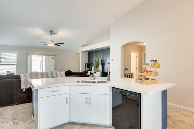 kitchen with arched walkways, vaulted ceiling, light countertops, black dishwasher, and open floor plan