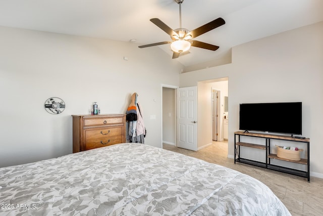 bedroom with a ceiling fan, baseboards, and vaulted ceiling