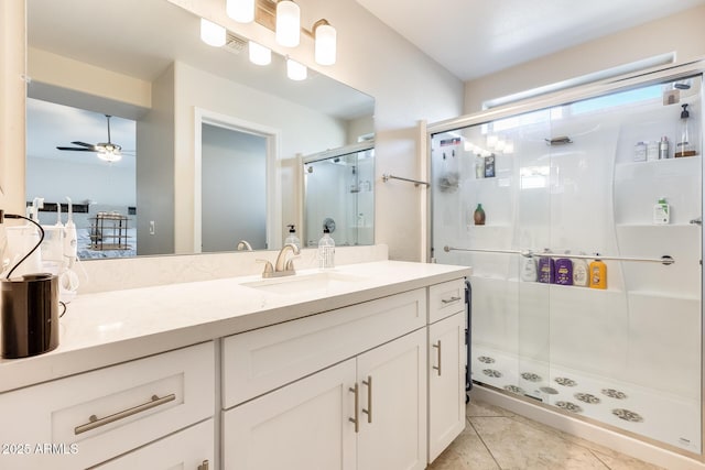 bathroom featuring visible vents, a stall shower, a ceiling fan, tile patterned flooring, and vanity