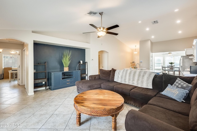 living area featuring visible vents, arched walkways, lofted ceiling, and ceiling fan