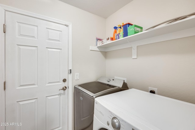 washroom featuring washer and clothes dryer and laundry area