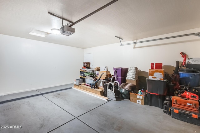 garage with a garage door opener and baseboards