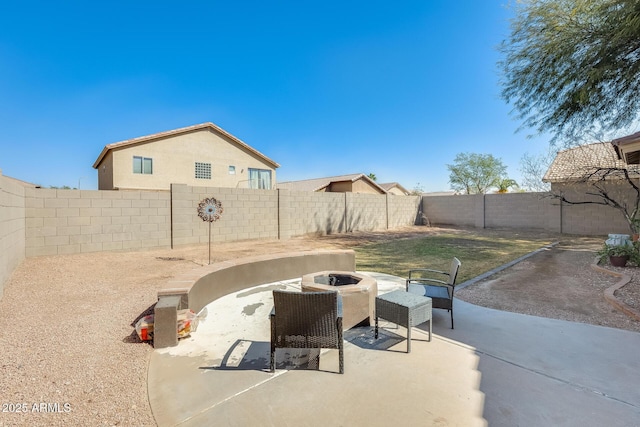 view of patio with an outdoor fire pit and a fenced backyard