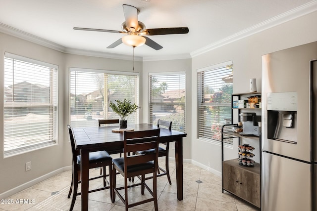 dining area with light tile patterned flooring, a ceiling fan, crown molding, and baseboards