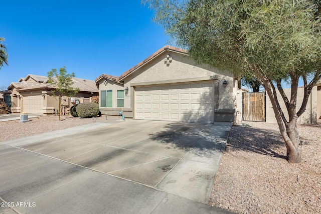 view of front facade with a tile roof, stucco siding, concrete driveway, and a garage