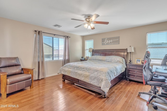 bedroom with baseboards, ceiling fan, visible vents, and light wood-type flooring