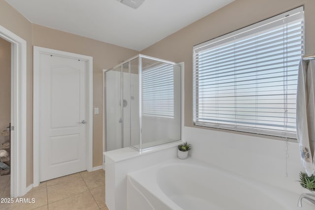 bathroom with a stall shower, tile patterned floors, and a garden tub