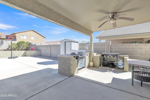 view of patio featuring a fenced backyard, an outdoor structure, a ceiling fan, and a shed