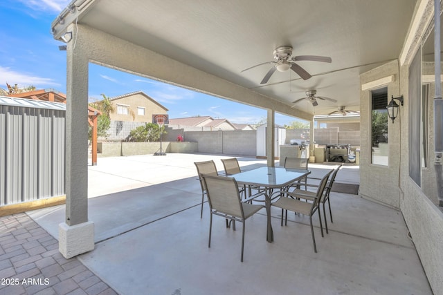 view of patio / terrace with outdoor dining area, a fenced backyard, and ceiling fan