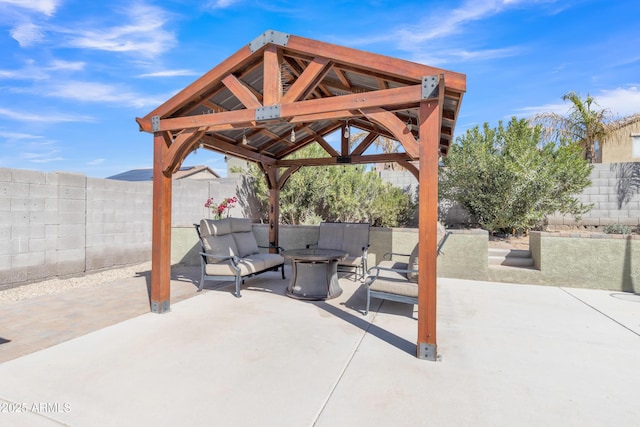 view of patio / terrace with an outdoor fire pit, a fenced backyard, and a gazebo