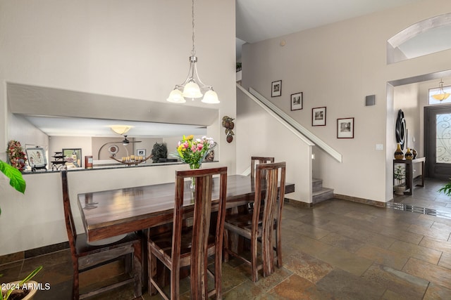 dining area featuring lofted ceiling and an inviting chandelier