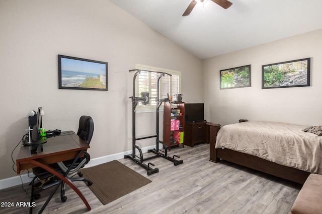 bedroom featuring ceiling fan, light hardwood / wood-style floors, and vaulted ceiling