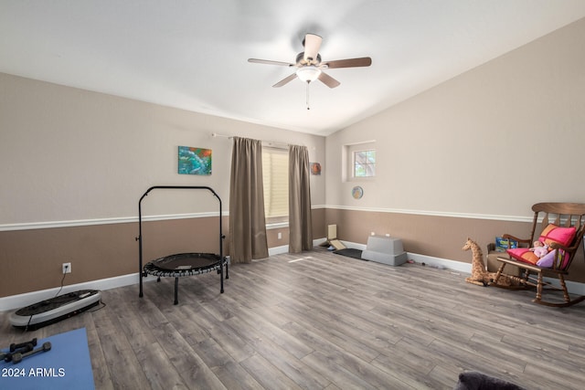 living area featuring ceiling fan, hardwood / wood-style floors, and lofted ceiling