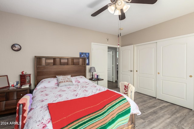 bedroom featuring hardwood / wood-style floors, ceiling fan, and a closet