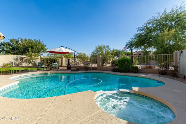 view of pool with a patio area and an in ground hot tub