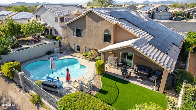 view of swimming pool featuring a mountain view, a patio, and an outdoor hangout area