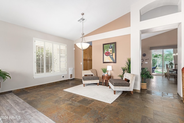 sitting room featuring a healthy amount of sunlight and lofted ceiling